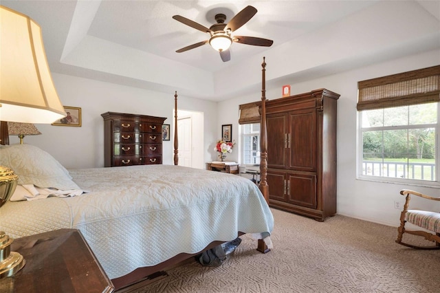 828 E Savoy St, Lecanto, FL 34461 - bedroom with light carpet, a tray ceiling, and a ceiling fan
