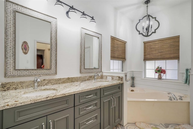 828 E Savoy St, Lecanto, FL 34461 - full bathroom with double vanity, a chandelier, and a bath