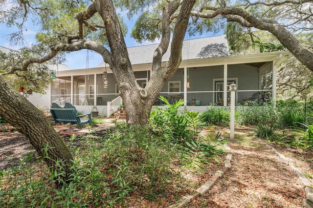 828 E Savoy St, Lecanto, FL 34461 - rear view of house featuring a sunroom