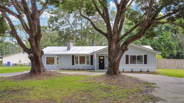 4233 Oak Ln, Saint Augustine, FL 32086 - ranch-style home featuring a chimney, a metal roof, and brick siding