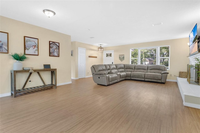 4233 Oak Ln, Saint Augustine, FL 32086 - living room with light wood-type flooring and a fireplace with raised hearth