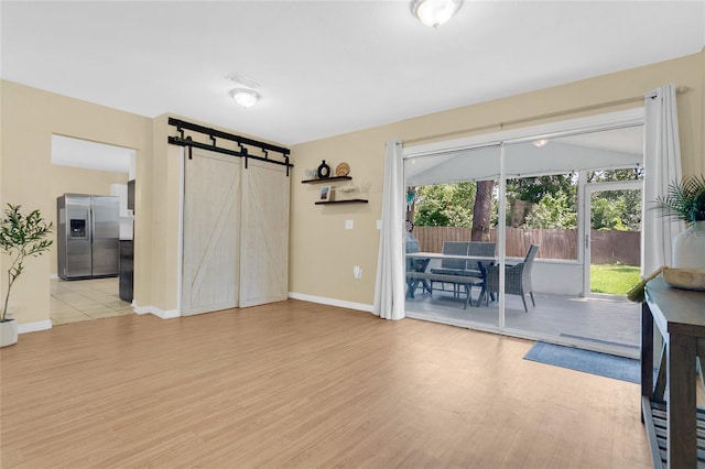 4233 Oak Ln, Saint Augustine, FL 32086 - dining space featuring a barn door and light wood-style flooring