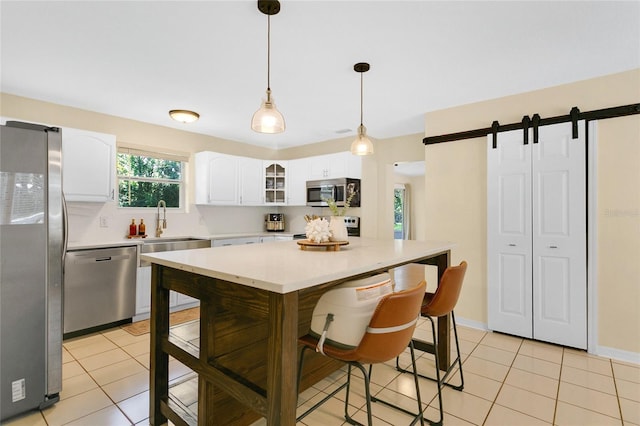 4233 Oak Ln, Saint Augustine, FL 32086 - kitchen with appliances with stainless steel finishes, light countertops, light tile patterned floors, white cabinets, and glass insert cabinets