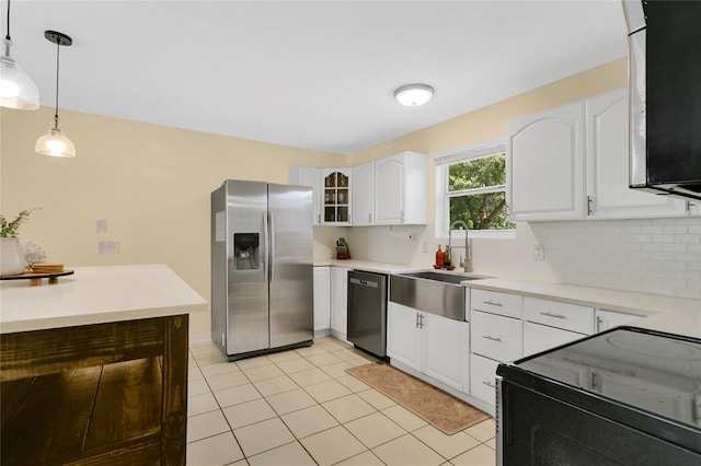 4233 Oak Ln, Saint Augustine, FL 32086 - kitchen featuring appliances with stainless steel finishes, decorative light fixtures, white cabinets, light tile patterned floors, and glass insert cabinets