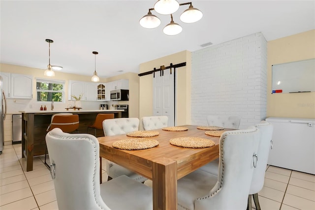 4233 Oak Ln, Saint Augustine, FL 32086 - dining area with light tile patterned floors and a barn door