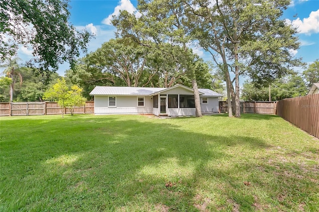4233 Oak Ln, Saint Augustine, FL 32086 - back of house featuring a sunroom and a fenced backyard