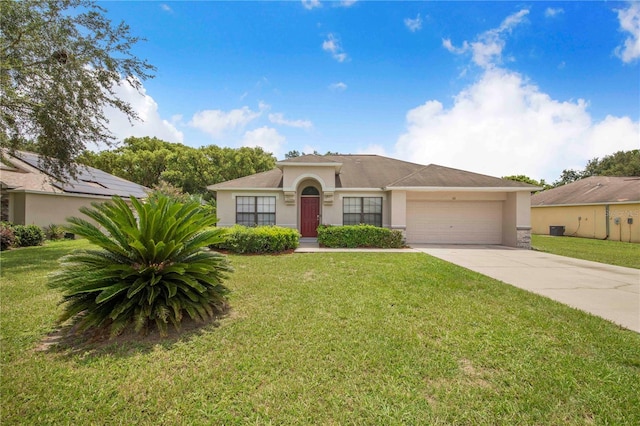 161 Oak Crossing Blvd, Auburndale, FL 33823 - view of front of house with stucco siding, a garage, concrete driveway, and a front lawn