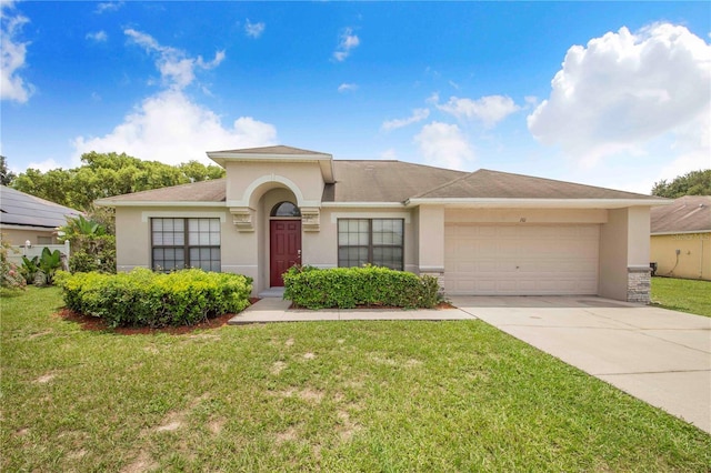 161 Oak Crossing Blvd, Auburndale, FL 33823 - mediterranean / spanish house with stucco siding, an attached garage, concrete driveway, and a front yard