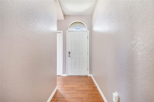 161 Oak Crossing Blvd, Auburndale, FL 33823 - doorway to outside with wood finished floors and a textured wall