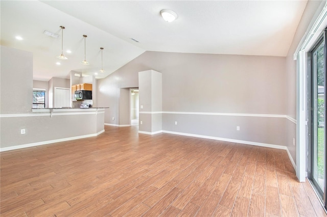 161 Oak Crossing Blvd, Auburndale, FL 33823 - unfurnished living room with vaulted ceiling and light wood-style floors