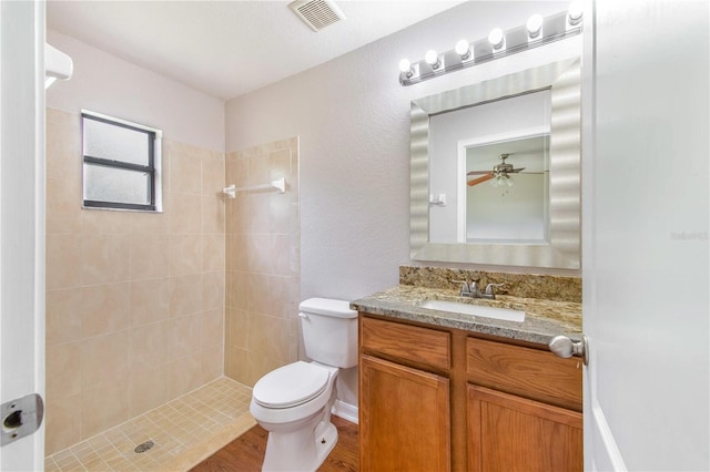 161 Oak Crossing Blvd, Auburndale, FL 33823 - full bathroom featuring tiled shower, vanity, wood finished floors, and a ceiling fan
