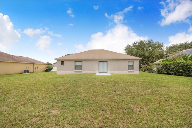 161 Oak Crossing Blvd, Auburndale, FL 33823 - back of house featuring a yard and stucco siding