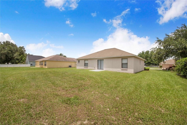 161 Oak Crossing Blvd, Auburndale, FL 33823 - back of property with a yard and stucco siding