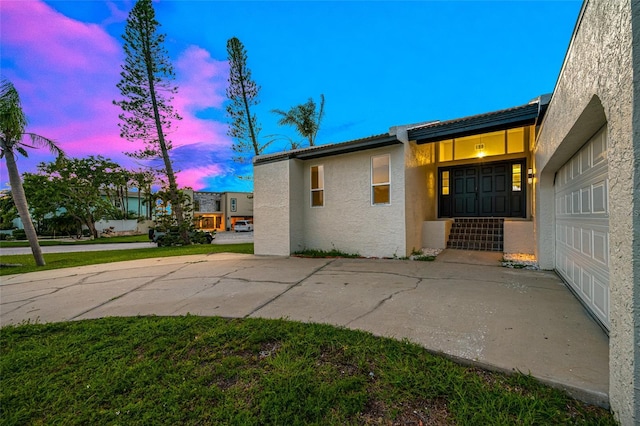 809 59th Ave, Saint Petersburg, FL 33706 - property exterior at dusk with stucco siding, a garage, and a tile roof