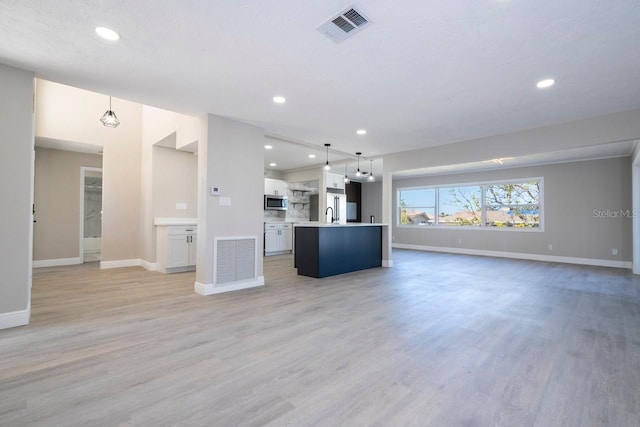 809 59th Ave, Saint Petersburg, FL 33706 - unfurnished living room with recessed lighting and light wood-type flooring