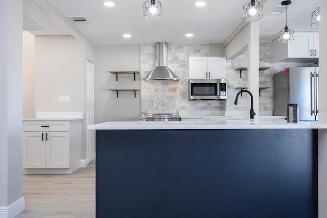 809 59th Ave, Saint Petersburg, FL 33706 - kitchen featuring wall chimney exhaust hood, appliances with stainless steel finishes, backsplash, white cabinets, and open shelves