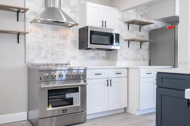 809 59th Ave, Saint Petersburg, FL 33706 - kitchen with range hood, stainless steel appliances, open shelves, white cabinetry, and light countertops