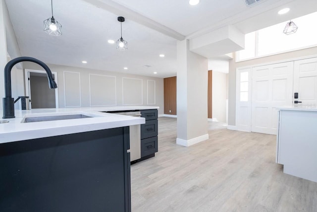 809 59th Ave, Saint Petersburg, FL 33706 - kitchen featuring light countertops, recessed lighting, light wood-style flooring, and decorative light fixtures