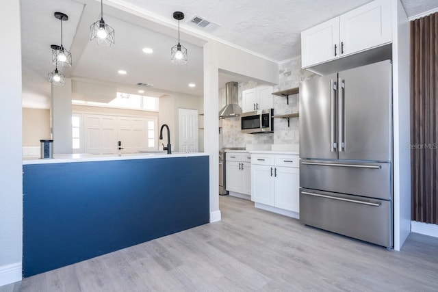 809 59th Ave, Saint Petersburg, FL 33706 - kitchen with stainless steel appliances, open shelves, decorative backsplash, white cabinetry, and light wood-style flooring