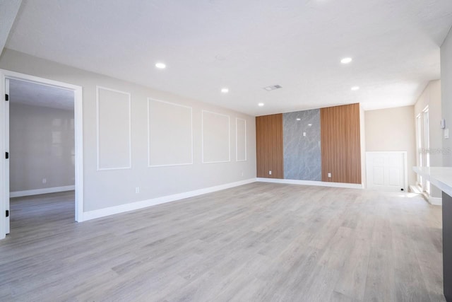 809 59th Ave, Saint Petersburg, FL 33706 - unfurnished living room featuring light wood-style floors and recessed lighting