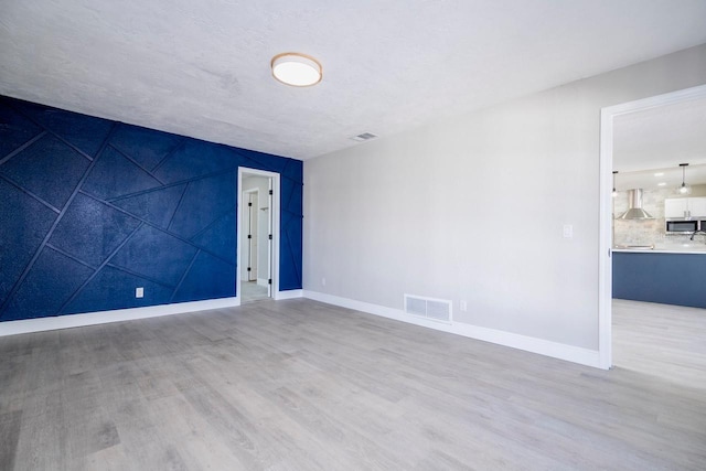 809 59th Ave, Saint Petersburg, FL 33706 - spare room featuring wood finished floors and baseboards