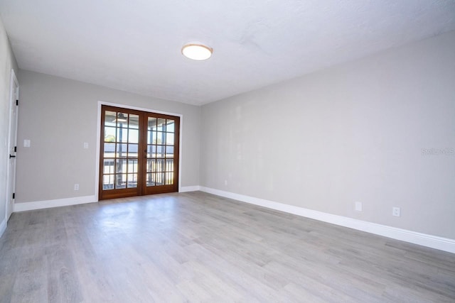 809 59th Ave, Saint Petersburg, FL 33706 - empty room featuring french doors and wood finished floors