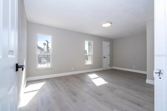 809 59th Ave, Saint Petersburg, FL 33706 - empty room with plenty of natural light and wood finished floors