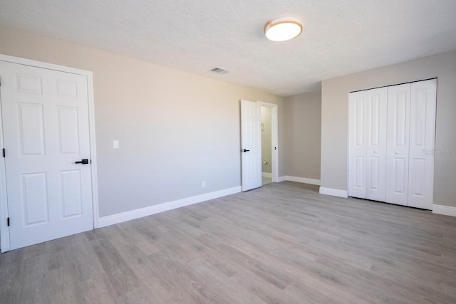 809 59th Ave, Saint Petersburg, FL 33706 - unfurnished bedroom with light wood-style flooring and a closet