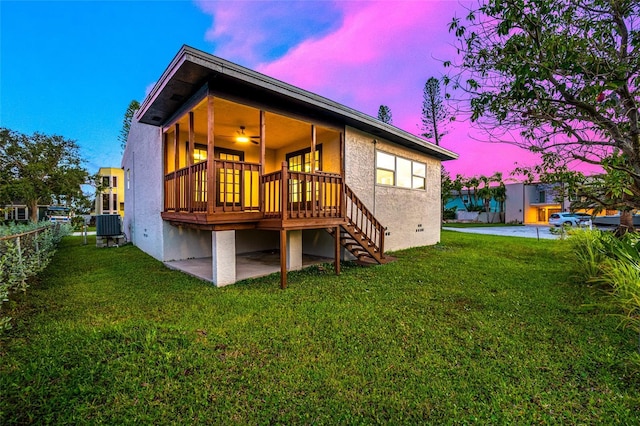 809 59th Ave, Saint Petersburg, FL 33706 - rear view of property featuring stairs, a lawn, and stucco siding