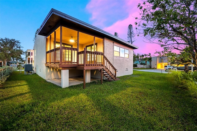 809 59th Ave, Saint Petersburg, FL 33706 - back of house featuring stairway, a yard, a deck, and stucco siding