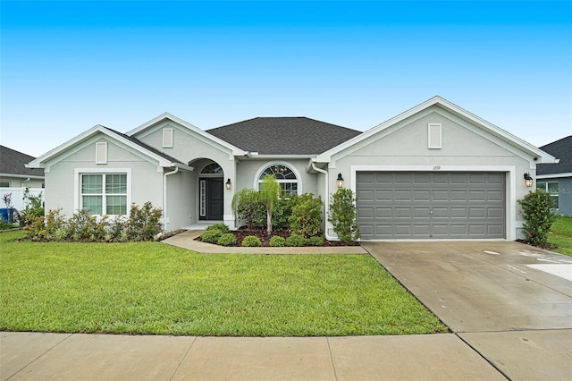 11539 Sunder Berry St, Hudson, FL 34667 - single story home featuring driveway, a front yard, stucco siding, and an attached garage