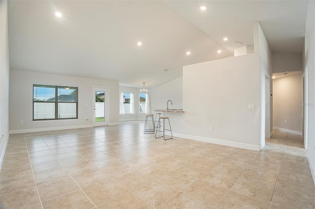 11539 Sunder Berry St, Hudson, FL 34667 - unfurnished living room with light tile patterned flooring, recessed lighting, a chandelier, and lofted ceiling