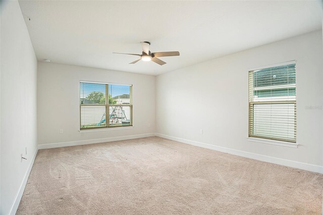 11539 Sunder Berry St, Hudson, FL 34667 - empty room featuring light colored carpet and a ceiling fan