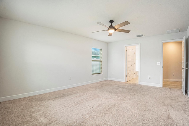 11539 Sunder Berry St, Hudson, FL 34667 - unfurnished bedroom with light carpet, ensuite bath, and a ceiling fan