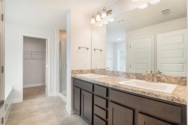 11539 Sunder Berry St, Hudson, FL 34667 - full bathroom featuring double vanity, a stall shower, a walk in closet, and tile patterned floors