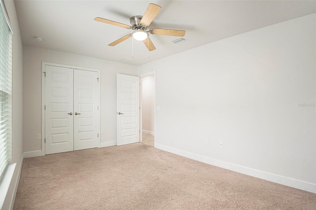 11539 Sunder Berry St, Hudson, FL 34667 - unfurnished bedroom with light carpet, a closet, and ceiling fan