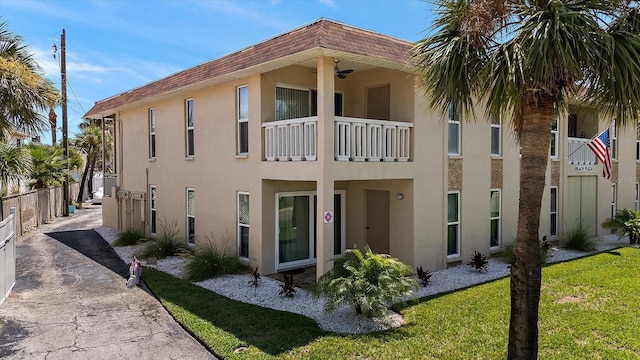 7003 Sunset Way Unit 6, St Pete Beach, FL 33706 - back of house featuring stucco siding and a ceiling fan