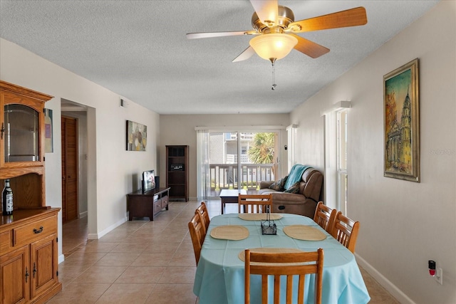 7003 Sunset Way Unit 6, St Pete Beach, FL 33706 - dining room with a textured ceiling, a ceiling fan, and light tile patterned floors