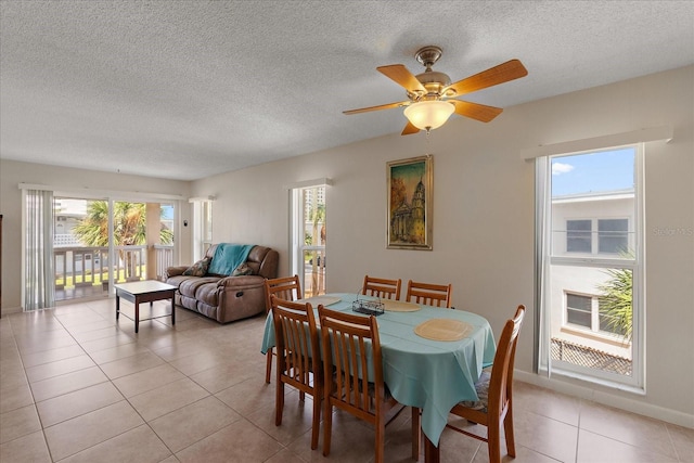 7003 Sunset Way Unit 6, St Pete Beach, FL 33706 - dining area featuring light tile patterned floors, ceiling fan, and a textured ceiling