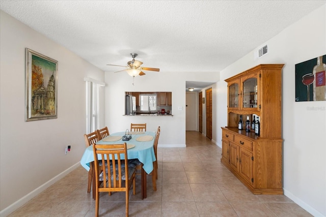 7003 Sunset Way Unit 6, St Pete Beach, FL 33706 - dining room with ceiling fan, light tile patterned flooring, and a textured ceiling