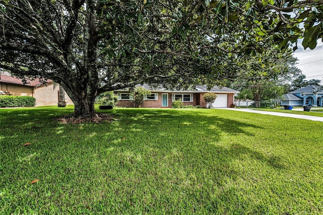 607 Spring Blossom Ct, Brandon, FL 33511 - ranch-style house featuring driveway, a front yard, an attached garage, and brick siding