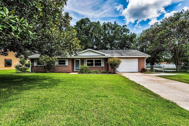 607 Spring Blossom Ct, Brandon, FL 33511 - ranch-style home with an attached garage, concrete driveway, and brick siding