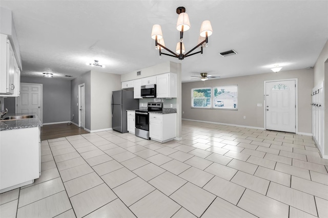 607 Spring Blossom Ct, Brandon, FL 33511 - kitchen with stainless steel appliances, a chandelier, a ceiling fan, white cabinetry, and light tile patterned floors