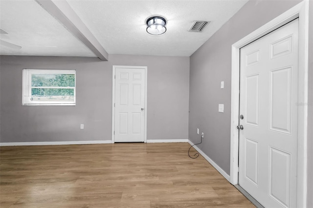 607 Spring Blossom Ct, Brandon, FL 33511 - empty room with light wood-type flooring and a textured ceiling