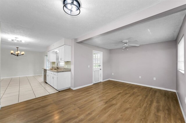 607 Spring Blossom Ct, Brandon, FL 33511 - kitchen with stainless steel dishwasher, a textured ceiling, a chandelier, white cabinets, and ceiling fan