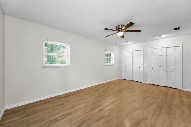 607 Spring Blossom Ct, Brandon, FL 33511 - unfurnished bedroom featuring light wood-style floors, multiple closets, and a ceiling fan