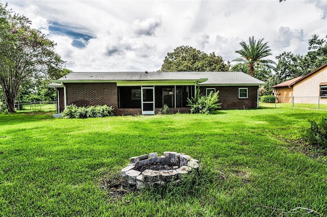 607 Spring Blossom Ct, Brandon, FL 33511 - back of property with brick siding, a sunroom, and a fire pit