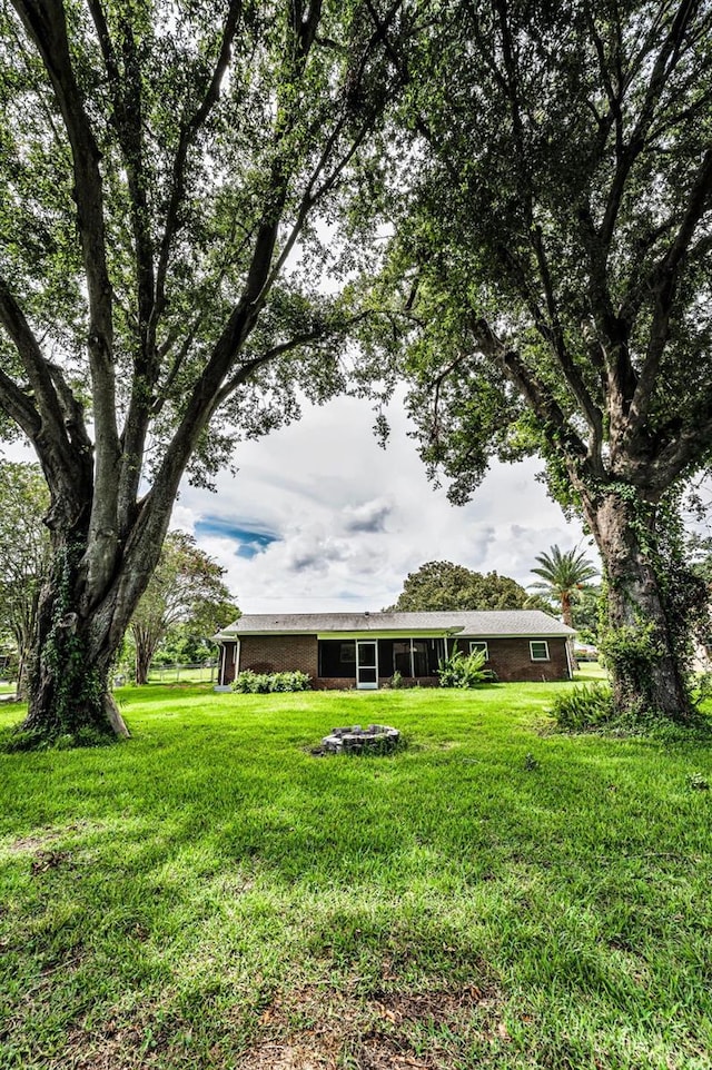607 Spring Blossom Ct, Brandon, FL 33511 - view of grassy yard featuring an outdoor fire pit