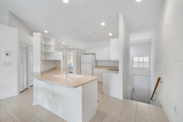 7018 Scrub Jay Way, Bradenton, FL 34203 - kitchen featuring freestanding refrigerator, a peninsula, light tile patterned floors, open shelves, and recessed lighting