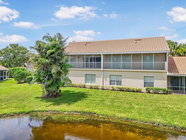 7018 Scrub Jay Way, Bradenton, FL 34203 - back of property featuring stucco siding, a sunroom, a lawn, and a water view